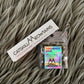 Catskill Meowtains book of 100% natural, organic hemp rolling papers and a nickle bag size package of Woodstock Weed organic catnip with a roach clip